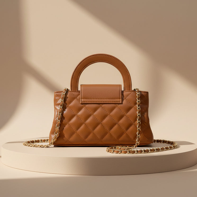 Brown handbag with a gold chain on a white background